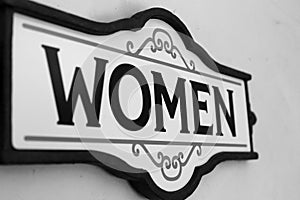 Women sign on wall closeup