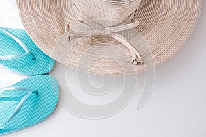 Elegant Women Sun Hat with Bow Blue Beach Slippers on White Background Seaside Vacation Relaxation