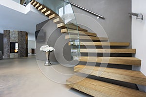 Elegant wood and glass staircase in luxury home