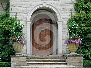 Elegant wood grain front door of stone house in round vestibule