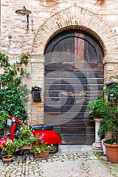 Elegant wooden door with red vespa