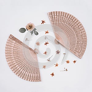 Elegant wooden fans and dried flowers photo