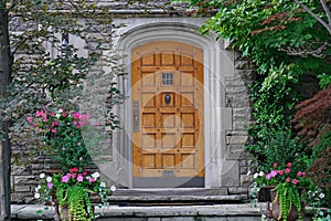 Elegant wooden front door of stone house