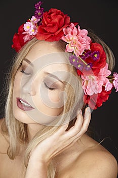 Elegant young blond woman with floral wreath in her hair