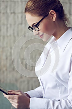 Elegant young businesswoman using tablet