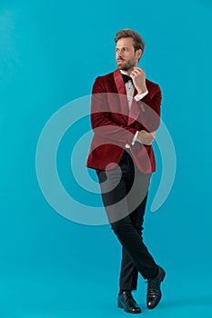 Elegant young fashion man wearing red velvet tuxedo