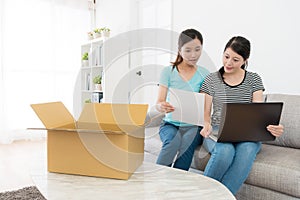 Elegant young female friends using mobile laptop