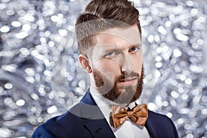 Elegant young handsome man in black classic costume. Studio fashion portrait