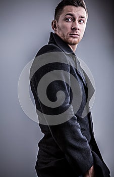 Elegant young handsome man. Studio fashion portrait on bright background.