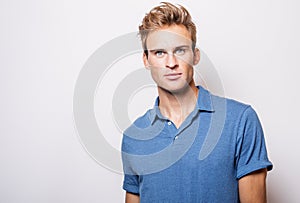 Elegant young handsome man in stylish blue shirt.