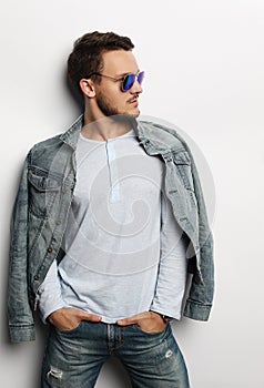 Elegant young handsome manin smart casual wear and sunglasses.