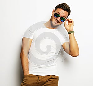 Elegant young handsome manin smart casual wear and sunglasses.