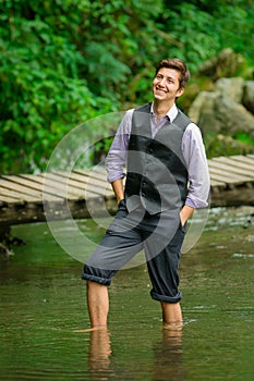 Elegant young man enjoying the nature with his