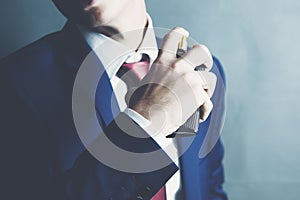 Man is perfuming himself