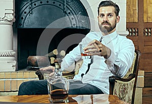 Elegant young man with whiskey and cigar