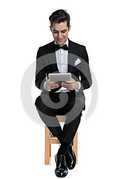 Elegant young model smiling and holding tab