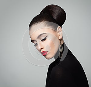 Elegant Young Woman with Hair Bun Hairstyle