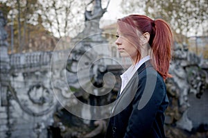 Elegant young woman, red-headed, wearing jacket