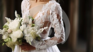 Elegantly attired bride embraces bouquet, her dress and details reflecting timeless love photo