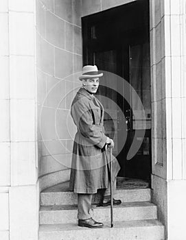 Elegantly dressed man standing in a door way of an office