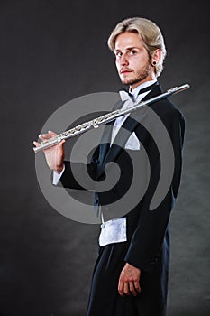 Elegantly dressed musician holding flute