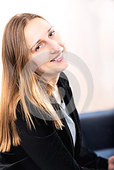 Elegantly dressed smiling young brunette woman