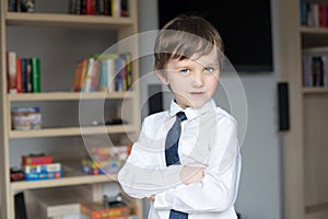 Elegantly dressed in a white shirt and tie little boy