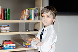 Elegantly dressed in a white shirt and tie little boy