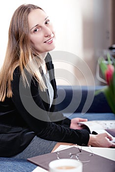 Elegantly dressed young brunette woman looking at camera