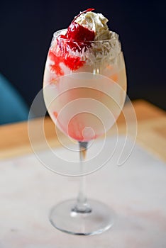 Elegantly presented strawberry and vanilla ice cocktail with fresh organic strawberry