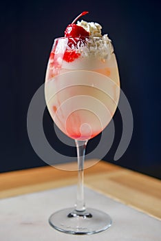 Elegantly presented strawberry and vanilla ice cocktail with fresh organic strawberry