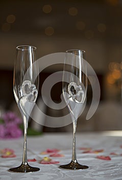 Elegantly served with wedding glasses, cutlery and decorated with flowers tables with white tablecloths and burning candles