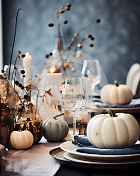 Elegantly set table with candles and white pumpkins. Pumpkin as a dish of thanksgiving for the harvest