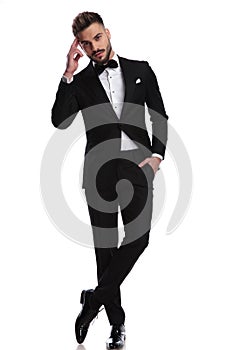 Elegnat man in tuxedo making a military salute