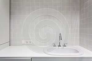 Element of bathroom interior. New wash basin, white sink and tile