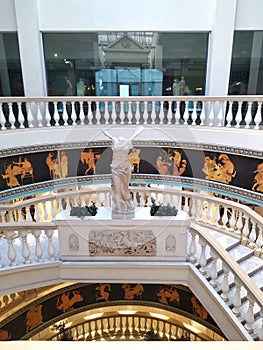 An element of Greek architecture - an antique-style staircase with a statue of Nika of Samothrace.