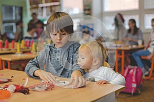 Elementary age child, creating art and craft product, dream catcher at school in art class