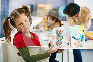 Elementary age children painting in classroom