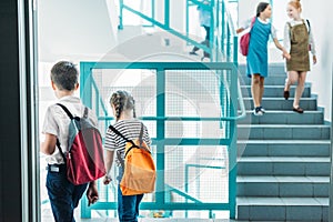 elementary age classmates walking down stairs photo