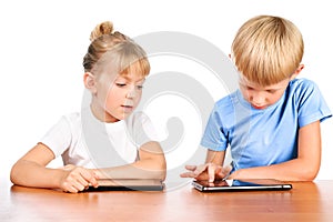 Elementary boy and girl at table with pads