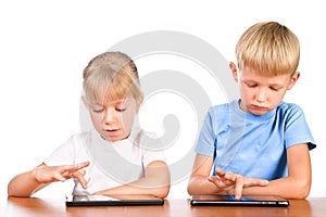 Elementary boy and girl using digital pads