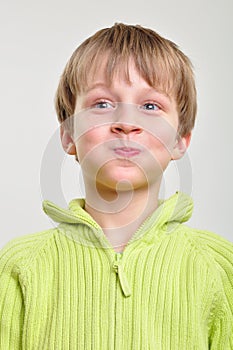 Elementary boy making funny faces