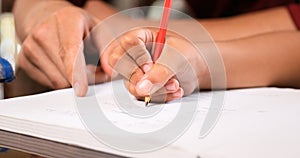 Elementary Girl Doing Homework Hand Writing On Exercise Book