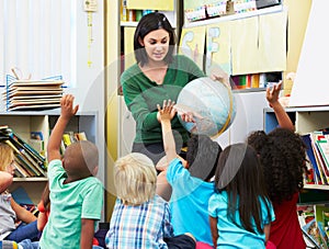 Elementary Pupils In Geography Class With Teacher photo