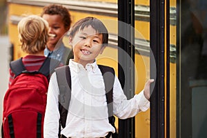 Elementary school boy at the front of the school bus queue