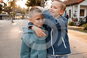 The elementary school boys are playing in the city.