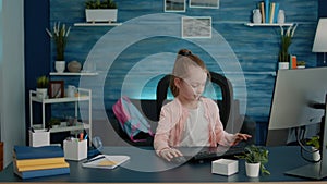 Elementary school child using computer and keyboard