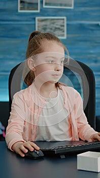 Elementary school child using computer and keyboard