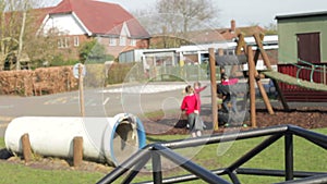 Elementary School Children Playing On Playground Equipment