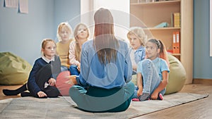 Elementary School Creativity Class: Diverse Children Sitting on Carpet while Teacher Explains Less